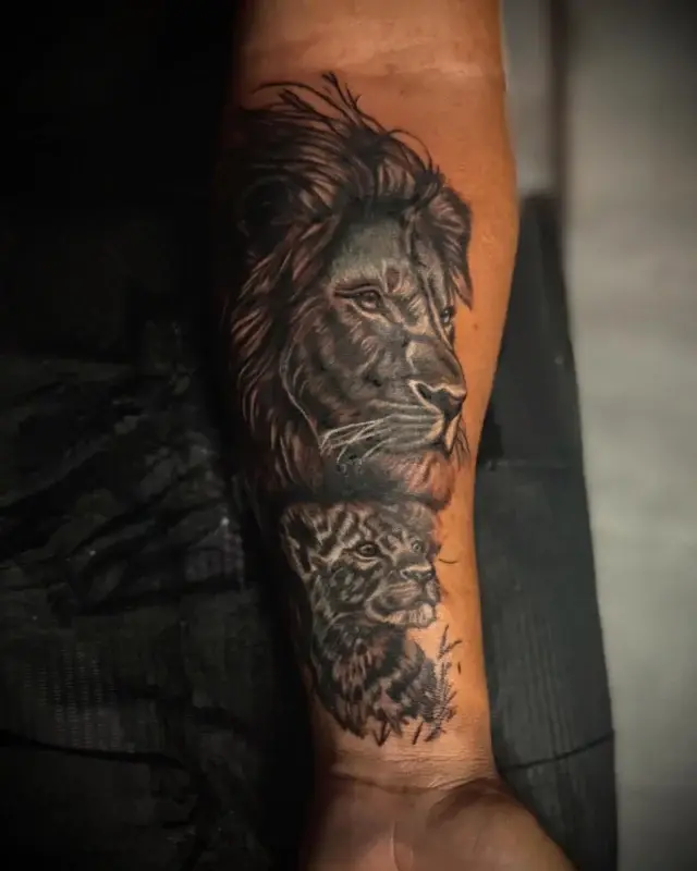 Tatuaje realista de león en el antebrazo